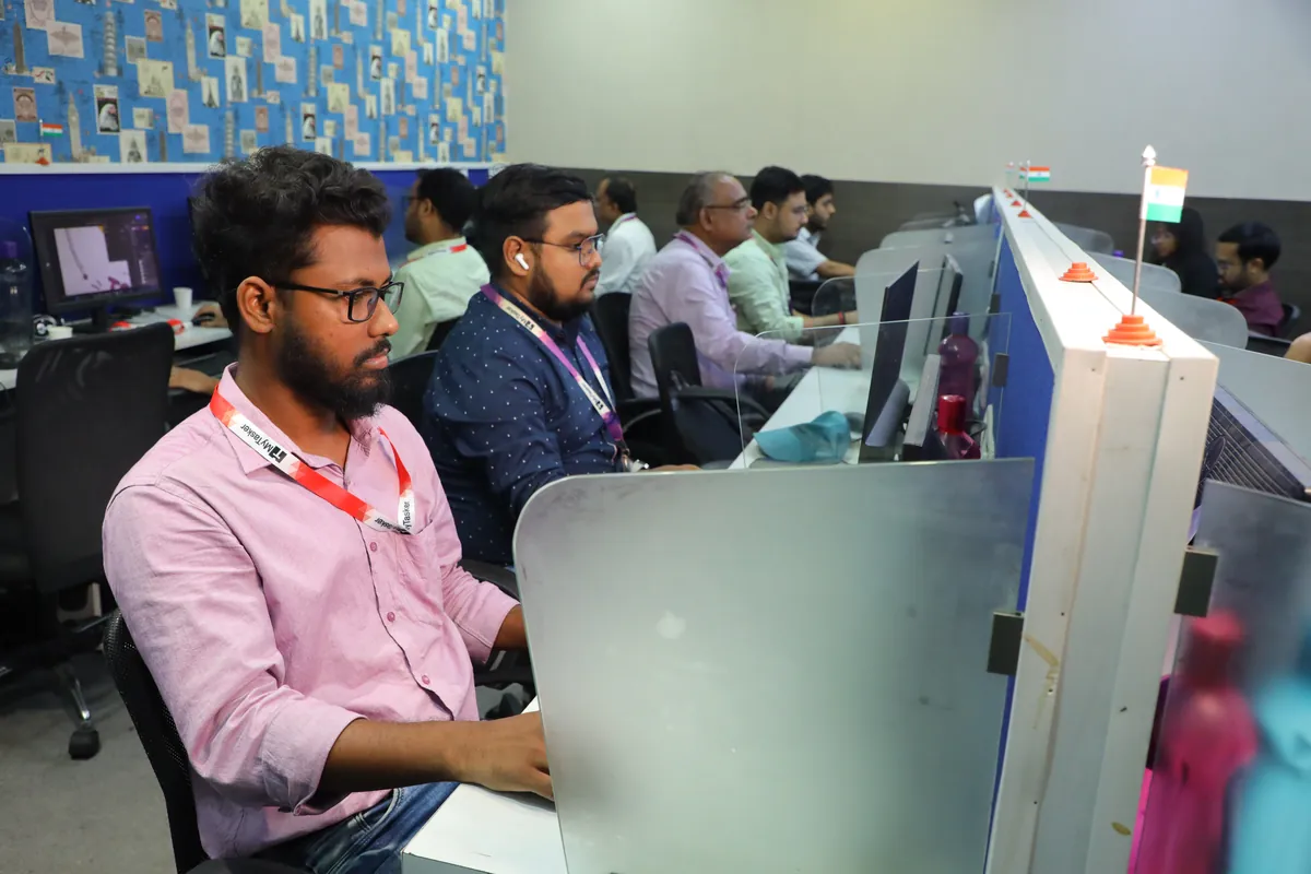 A MyTasker designer working on creative files alongside the wider team